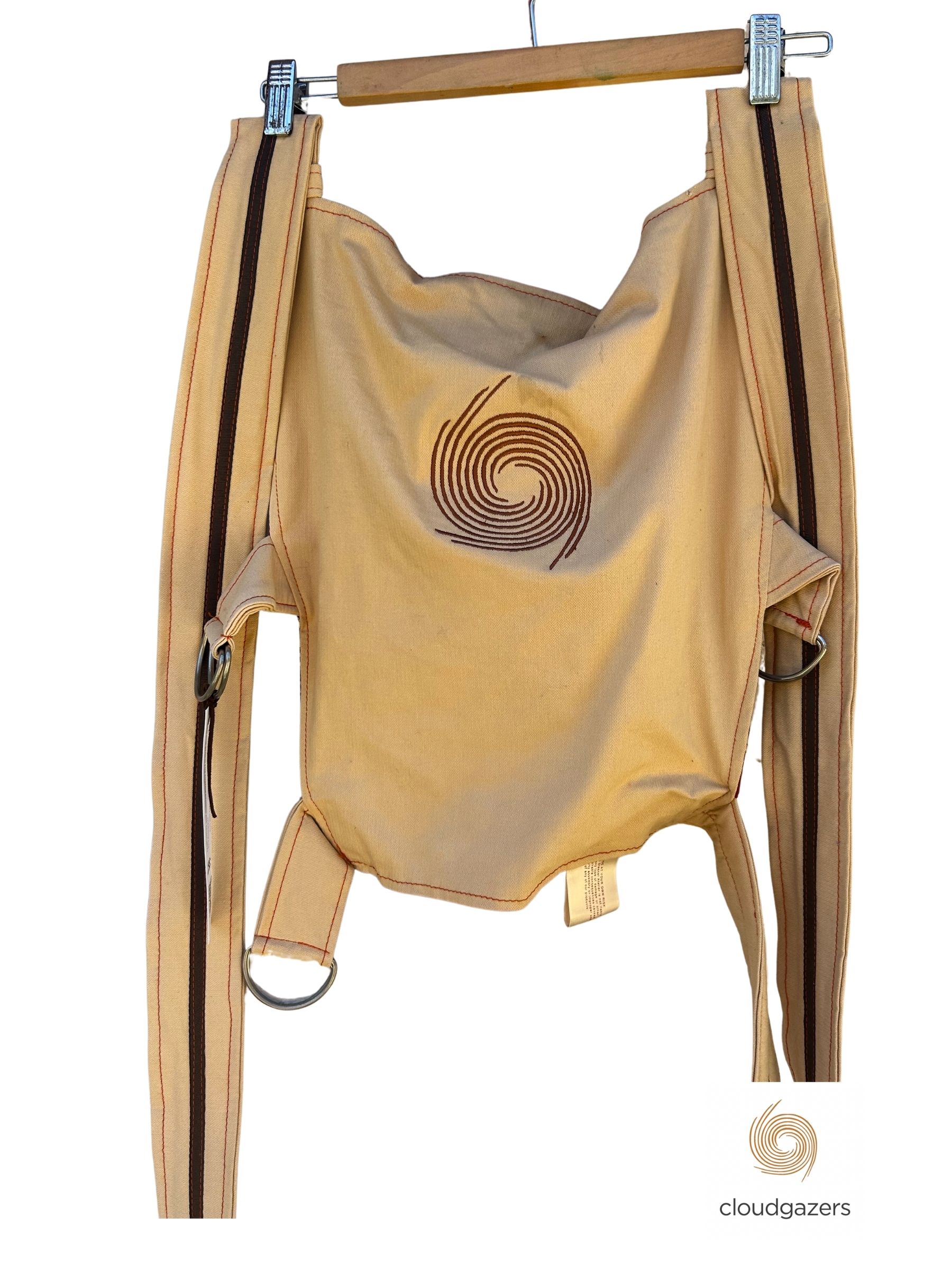 Handmade Baby Carrier One-of-One with swirl detail in orange and off-white corduroy, showcasing sustainable fashion design.