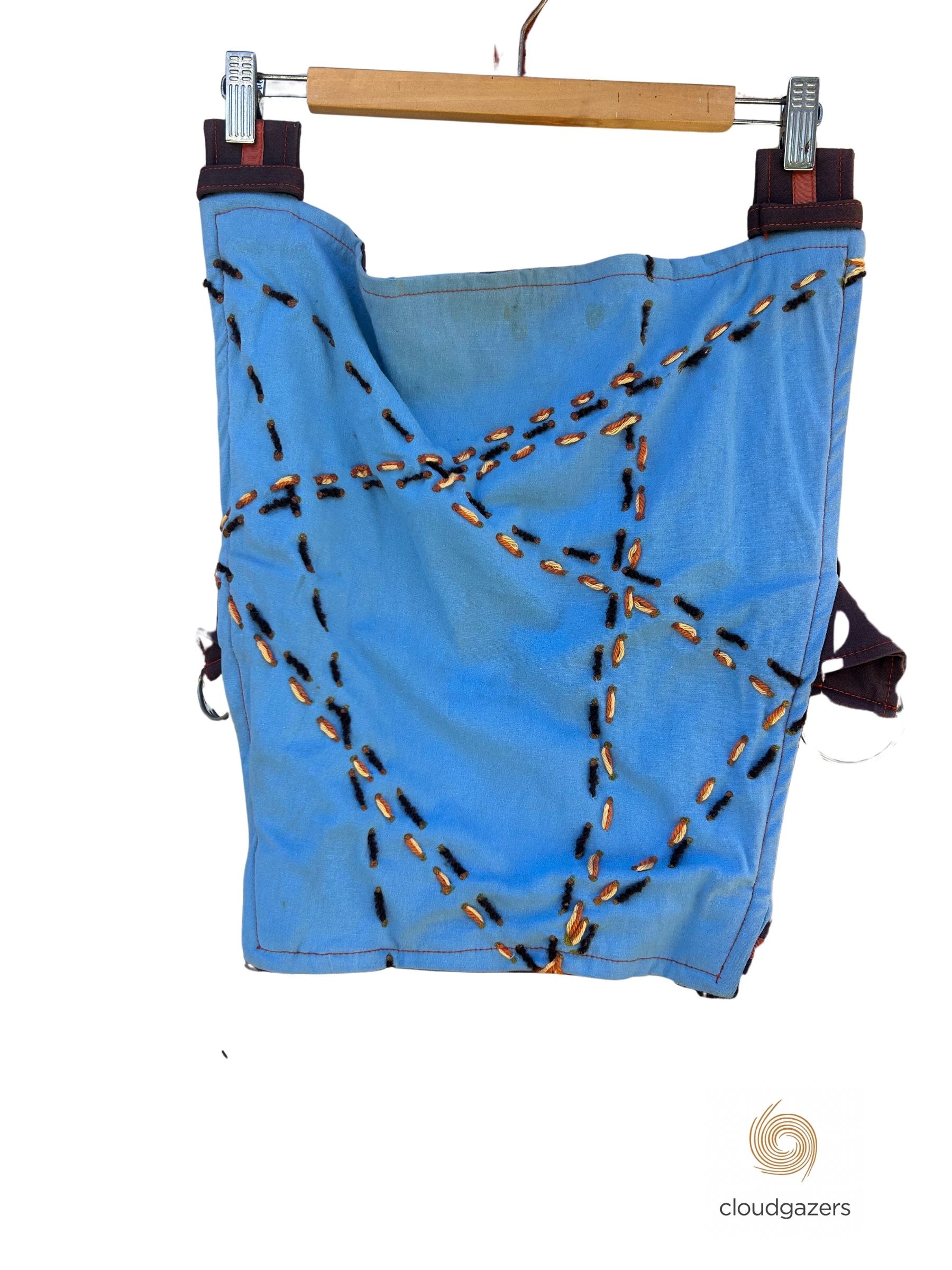 Baby Carrier Handmade One-of-One featuring blue fabric with intricate stitching details, showcasing unique sustainable fashion design.